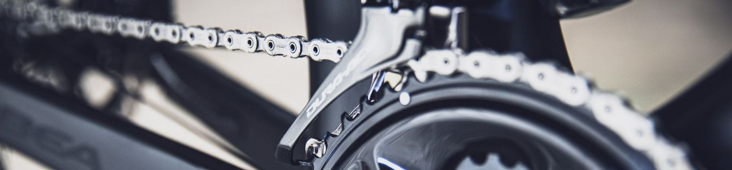 A detailed view of a bicycle chain and derailleur with the brand name Dura-Ace visible.