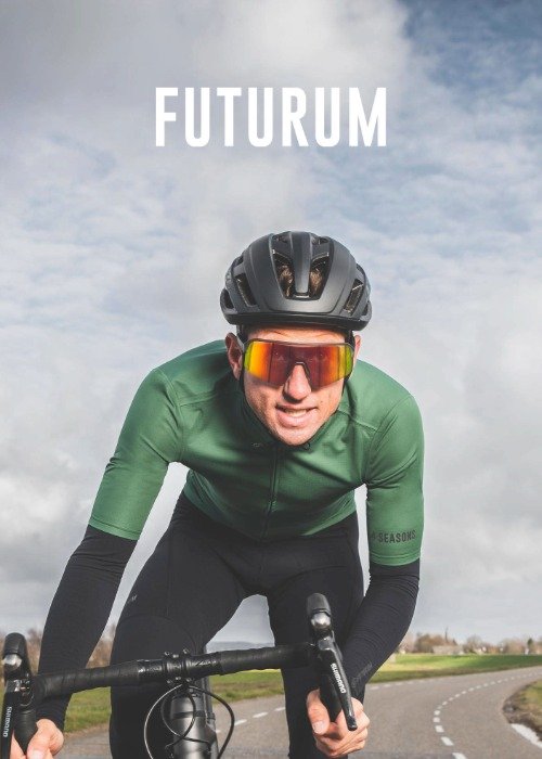 A cyclist wearing a green jersey and black helmet is riding on a road. The word 'FUTURUM' is visible above.