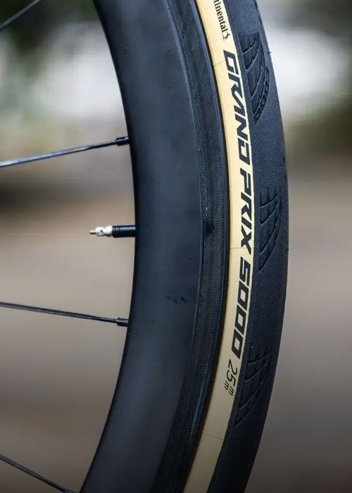 Close-up of a Continental Grand Prix 5000 bicycle tire with visible branding and tread pattern.